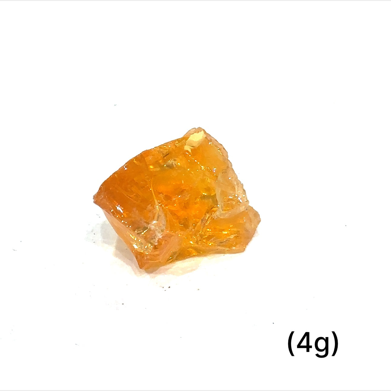 A collection of raw fire Ethiopian opal gemstones with varying colors, displayed on a white background, 4g.