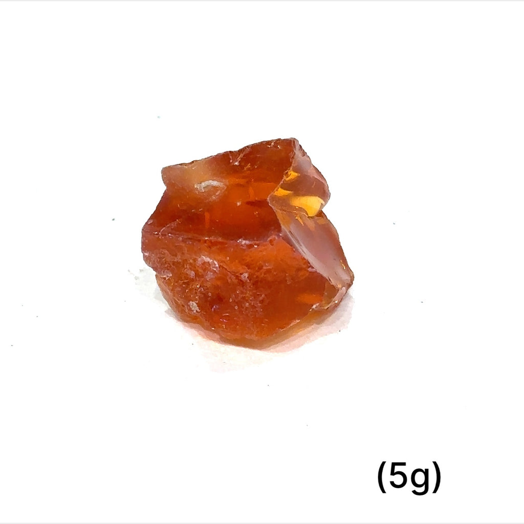 A collection of raw fire Ethiopian opal gemstones with varying colors, displayed on a white background, 5g.