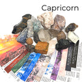 A collection of raw gemstones spread out, each labeled with its type, such as Aquamarine, Amethyst, and others. The label at the top says 'Capricorn'. front view. 