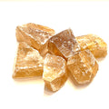 A collection of raw honey calcite gemstones displayed on a white background, front view.