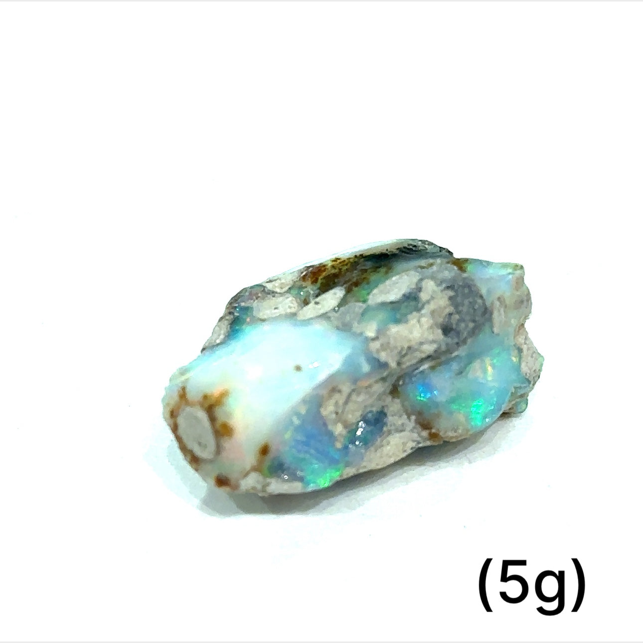 A collection of raw white Ethiopian opal gemstones with varying colors, displayed on a white background, 5g.