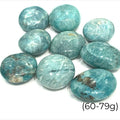 A collection of round Amazonite palm stones with a smooth, polished surface showcasing various shades of blue and green, on a white background. size (60-79g)