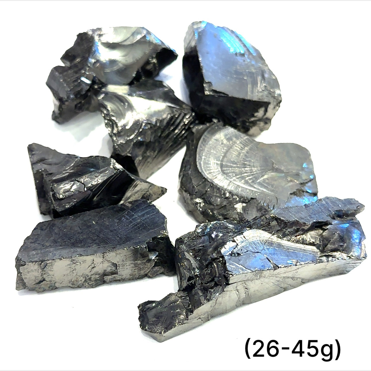 A collection of small raw Elite Shungite gemstone chunks (26-45g) on a white background, front overview. 
