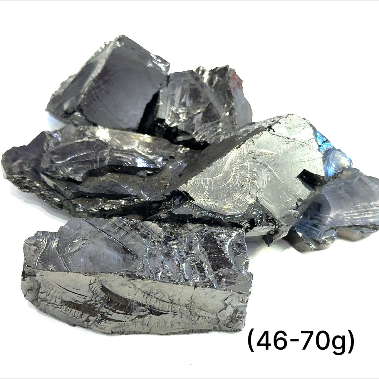A collection of small raw Elite Shungite gemstone chunks (46-70g) on a white background, front overview. 