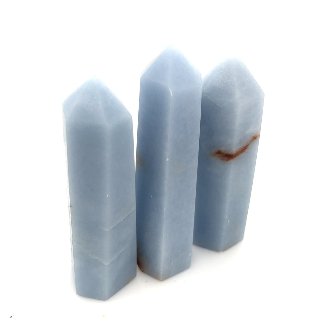 A collection of three Angelite gemstone towers displayed together on a white background front, center, close up  overview. 