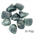 A collection of tumbled Seraphinite gemstones with a range of green hues and unique white markings on a white background, front view. size (0-10g)