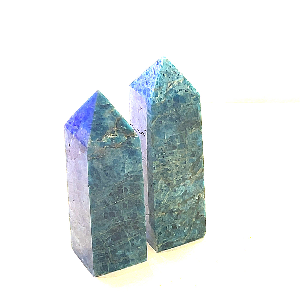 A collection of two Blue Apatite Gemstone Towers arranged in a line on a white background, side view.