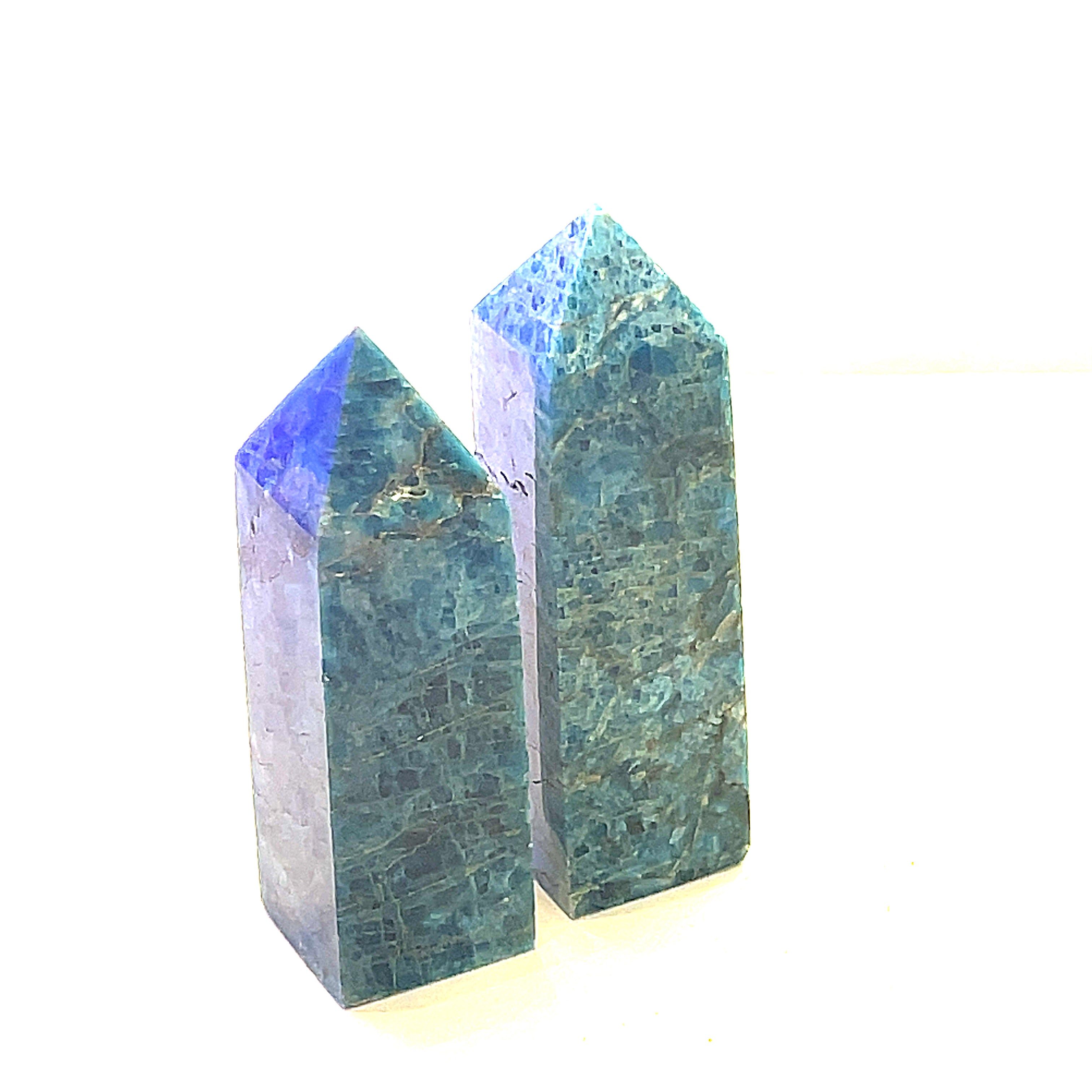 A collection of two Blue Apatite Gemstone Towers arranged in a line on a white background, side view.
