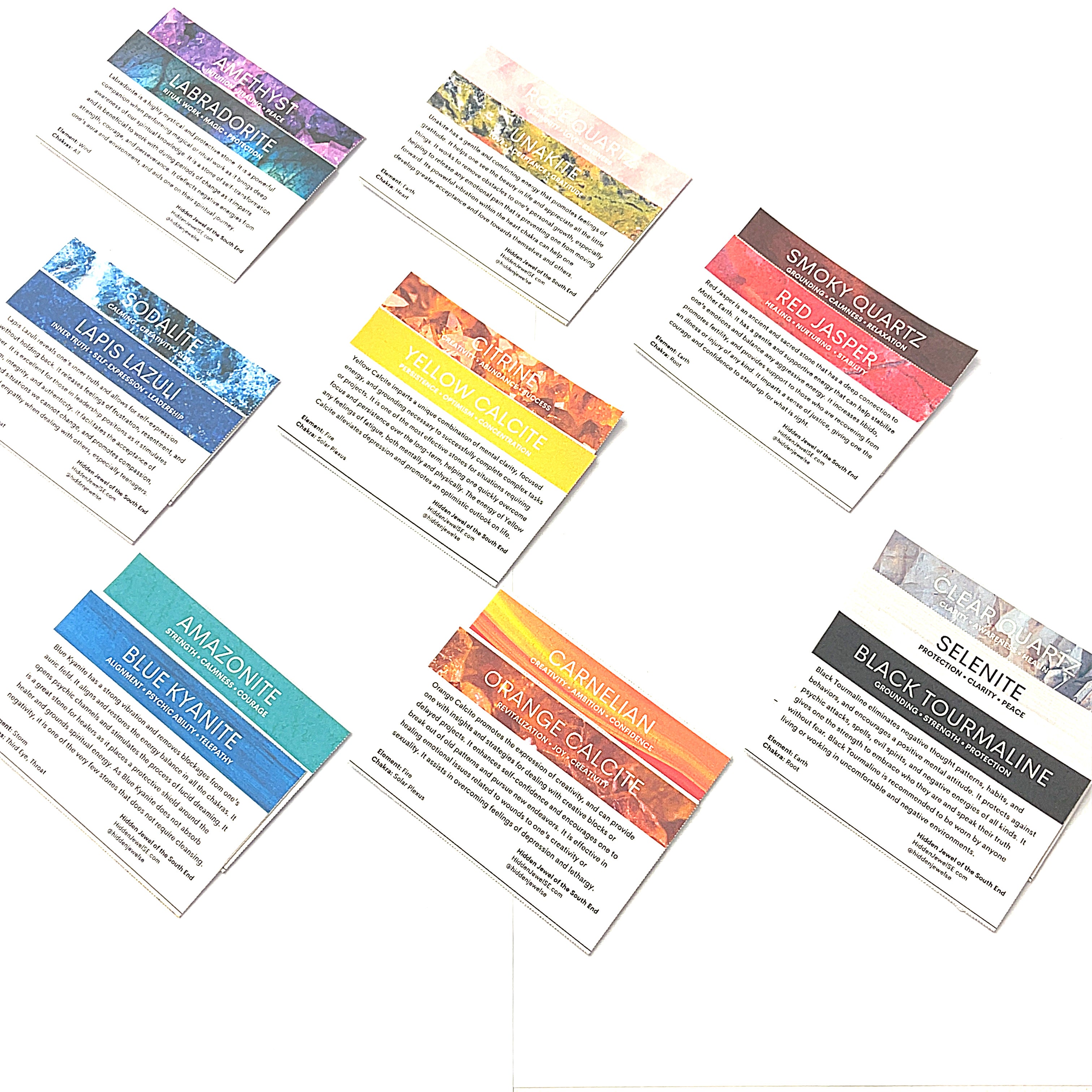 A collection of various raw gemstones information cards from the Chakra bag. on a white background in a front overview.