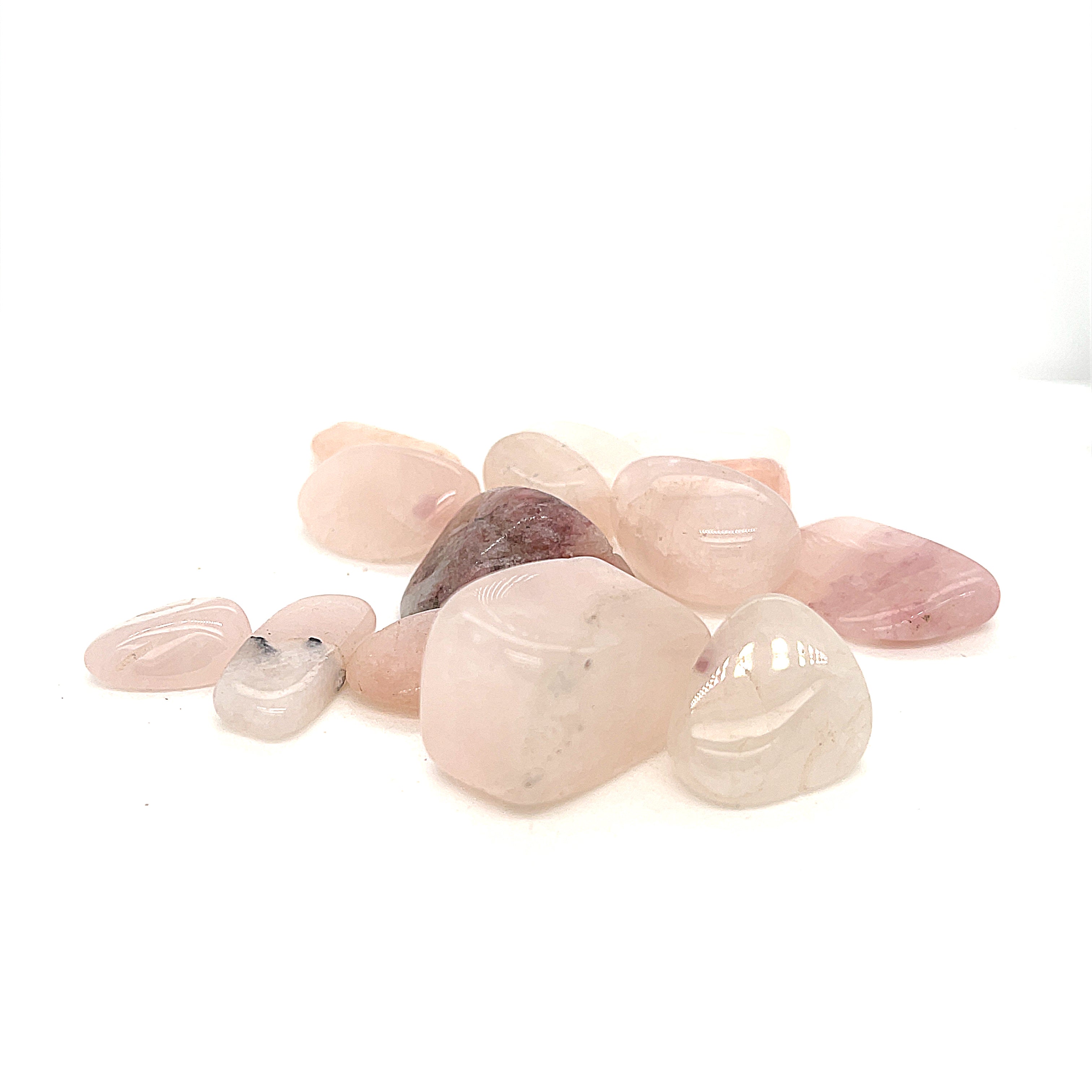 A collection of xs tumbled Petalite gemstones with a pink hue, displayed on a white background, front overview.