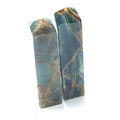 A collection of xtra large sizes of  blue onyx gemstone towers displayed in a group on a white background, front overview.