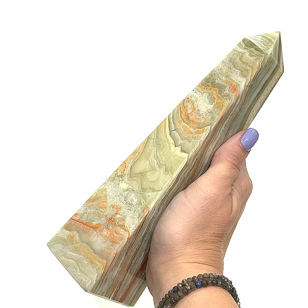 A ethically sourced Onyx towers from Hidden Jewel of the South End on a white background, front view in a models hand.