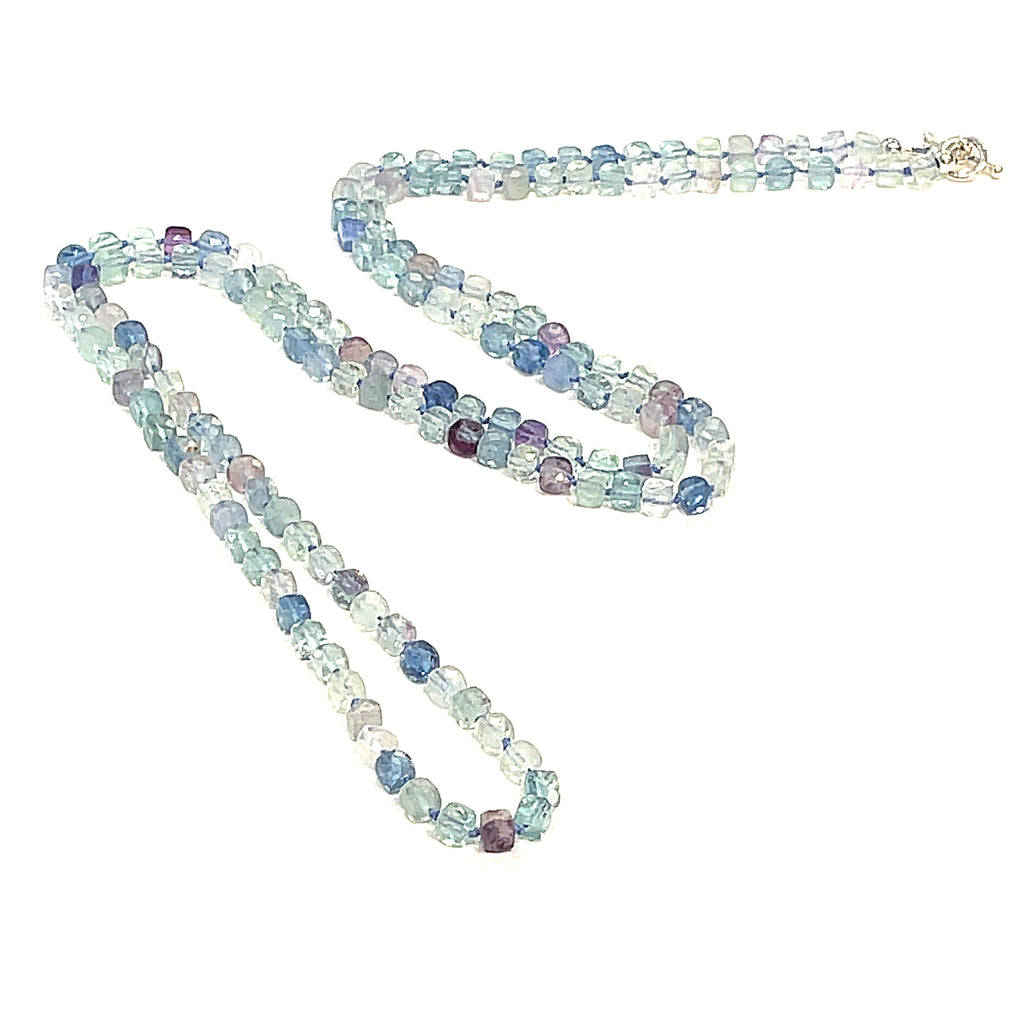A fluorite gemstone knotted necklace with a sterling silver toggle clasp, beaded on silk beading cord, long diagnoal  overview on a white background.
