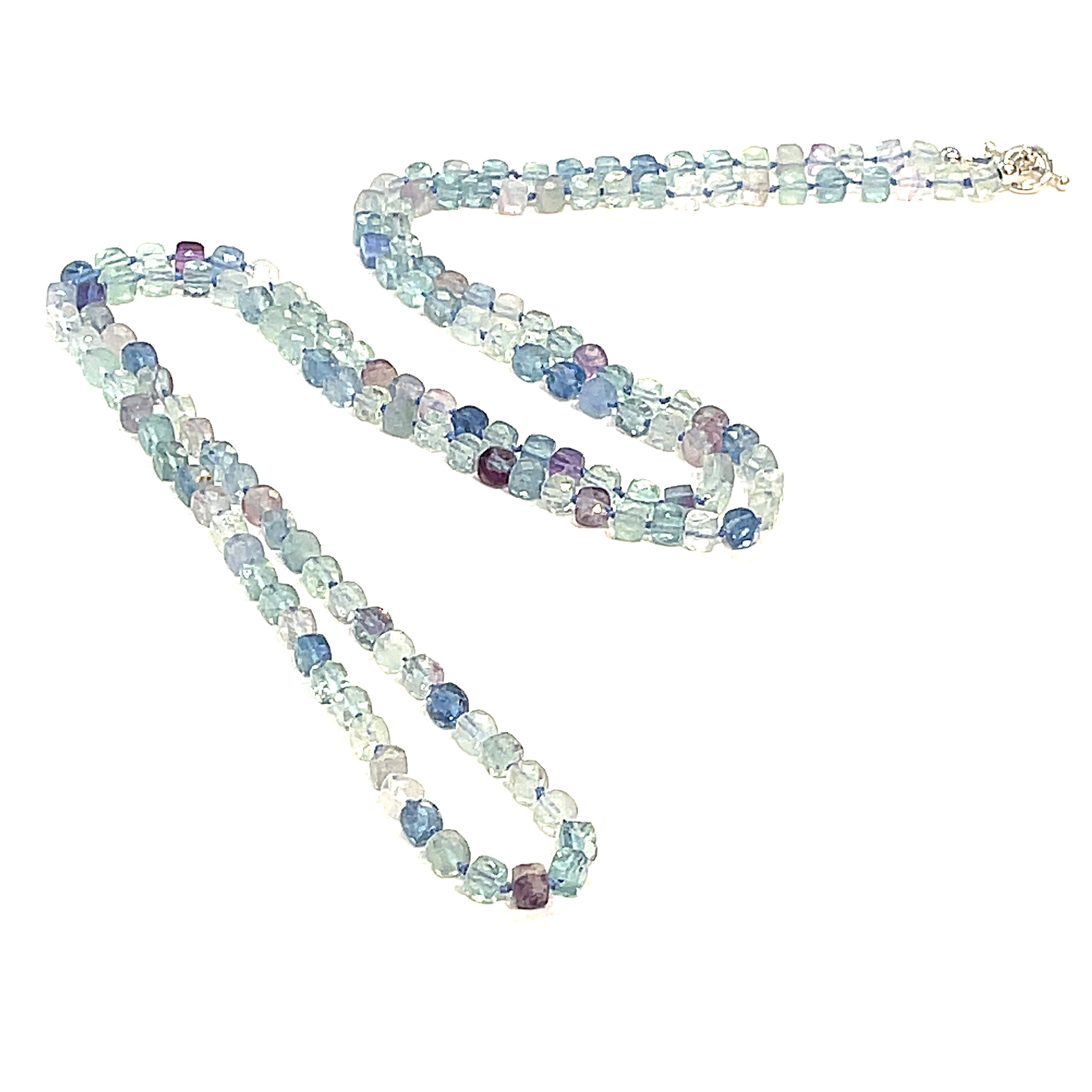 A fluorite gemstone knotted necklace with a sterling silver toggle clasp, beaded on silk beading cord, long diagnoal  overview on a white background.