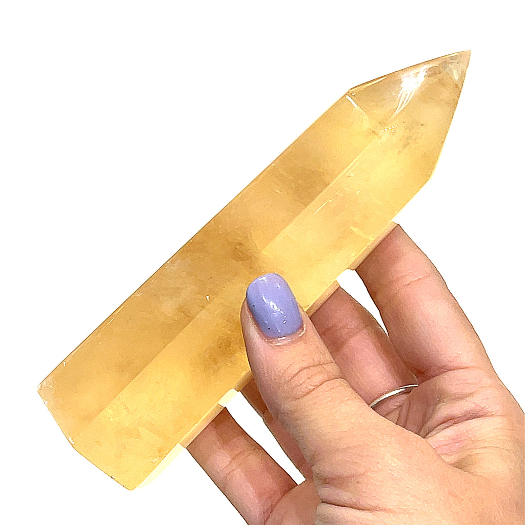 A fourth Honey Calcite gemstone tower displayed on a white background, front view.
