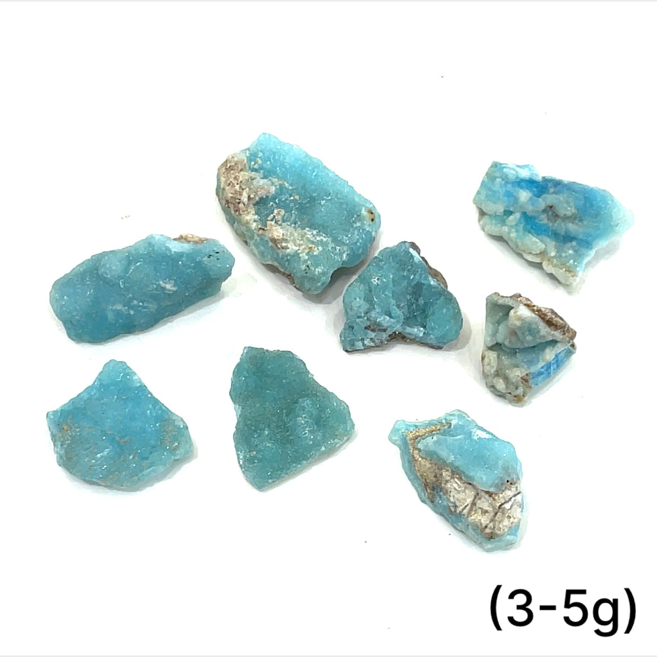 A group of (3-5g) of raw Hemimorphite pieces on  a white background, front view. 