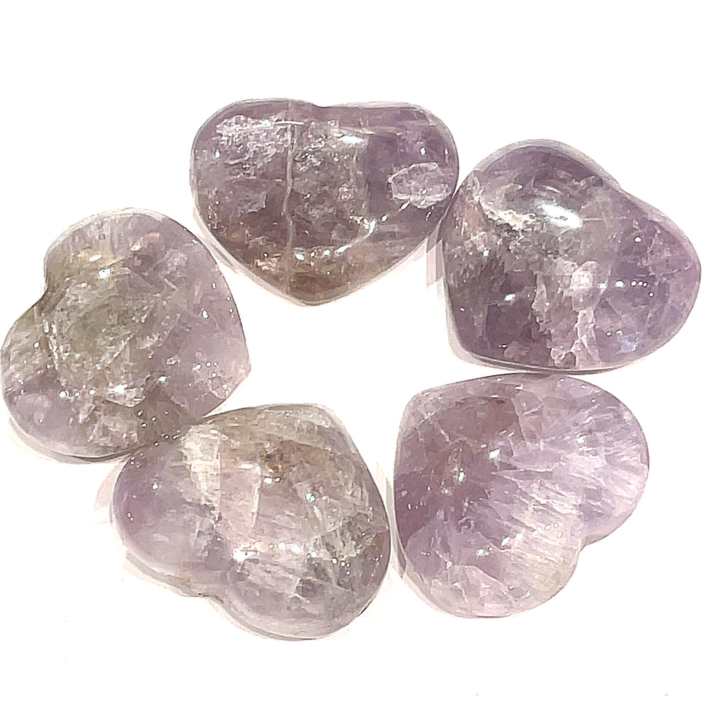 A group of 5 Super Seven gemstone heart carving, in a circle for a close-up, overview on a white background.
