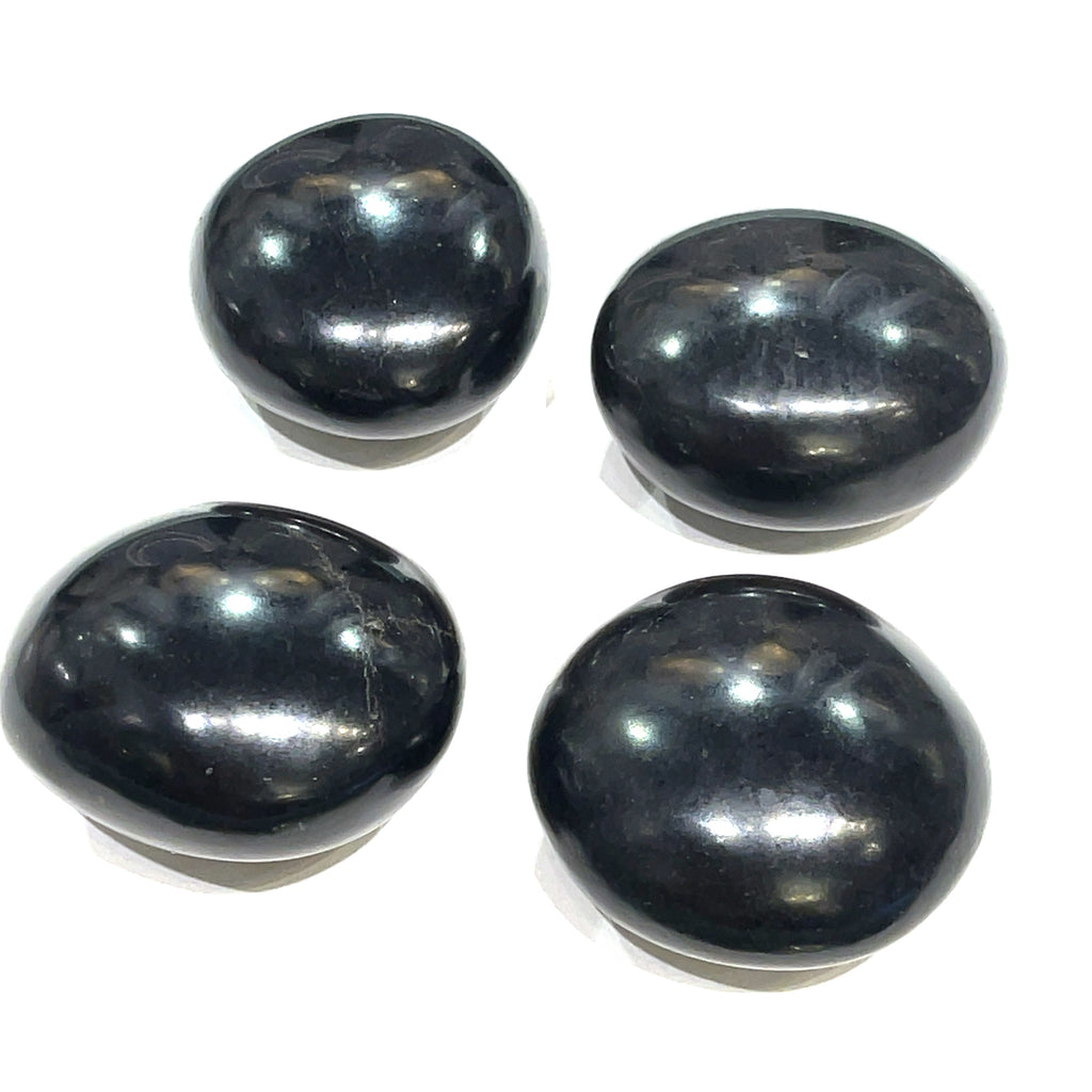 A group of Black Tourmaline gemstone palm stone on a white background, front overview. 