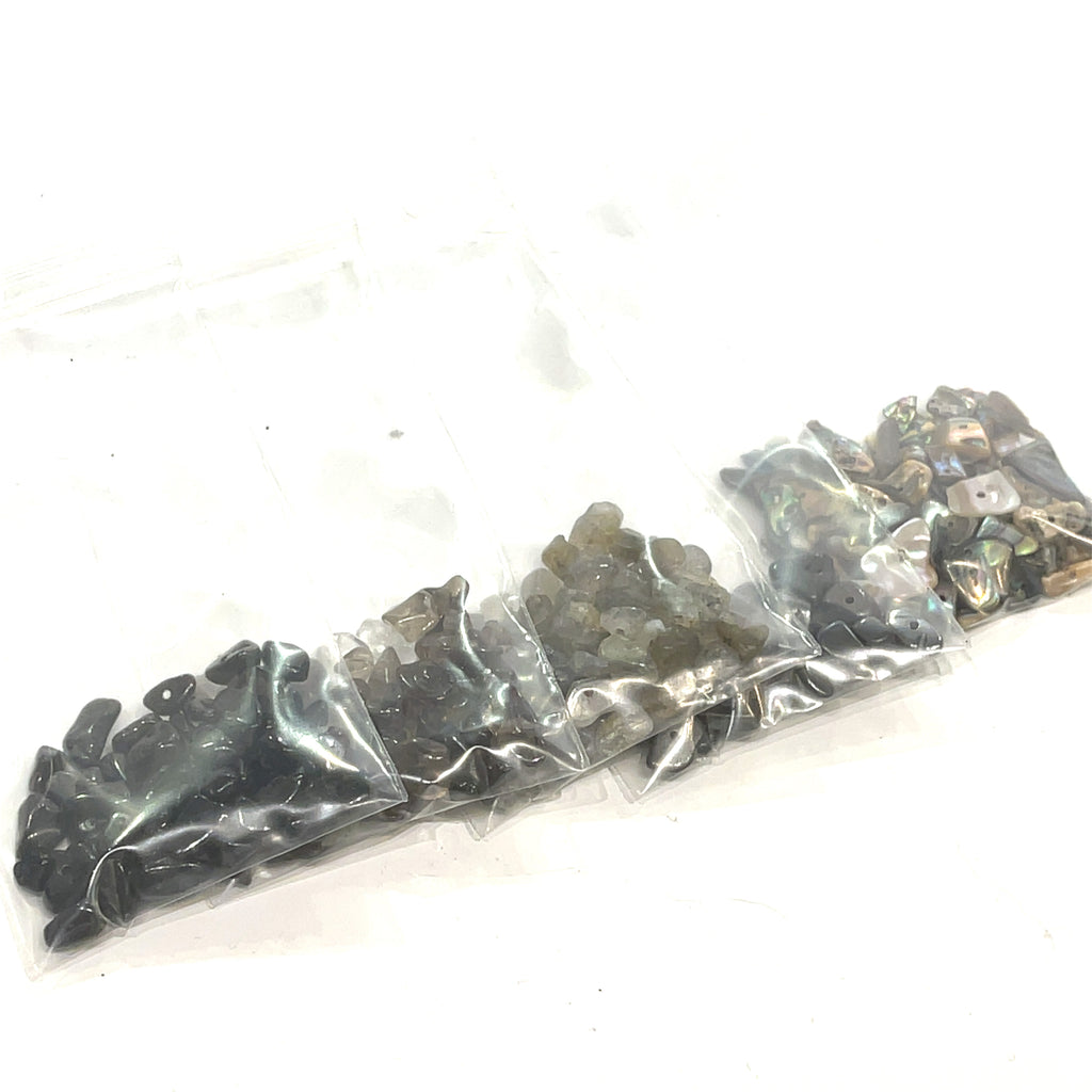 A group of Gray and black rays of gemstone chip bags, on a white background, front view.