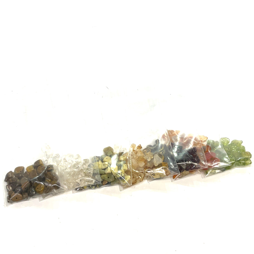 A group of Green, yellow, orange, and brown rays of gemstone chip bags, on a white background, front view.