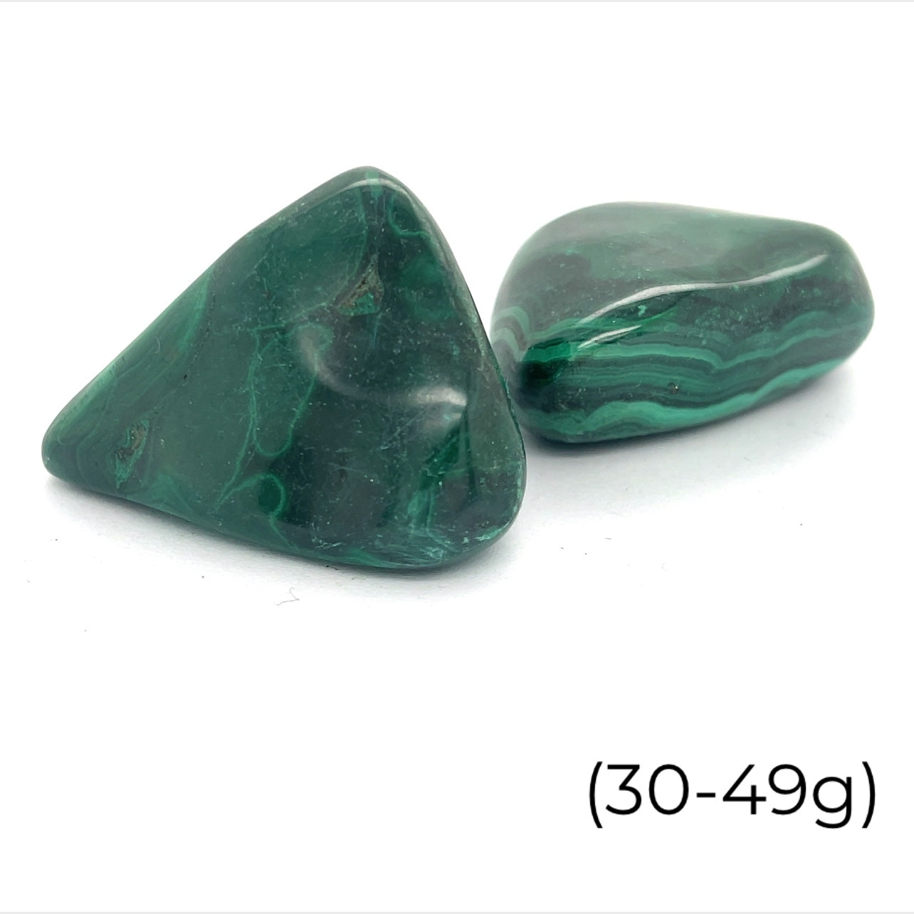 A group of Malachite tumbled (30-49g) gemstone  on a white background, front view.