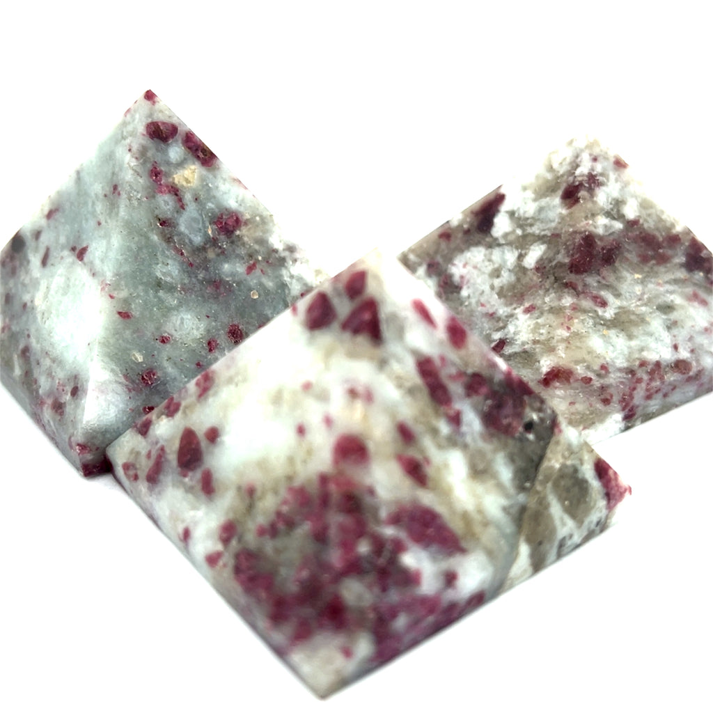 A group of  Pink Tourmaline Pyramid used for heart chakra meditation and energy healing on a white background overview. 