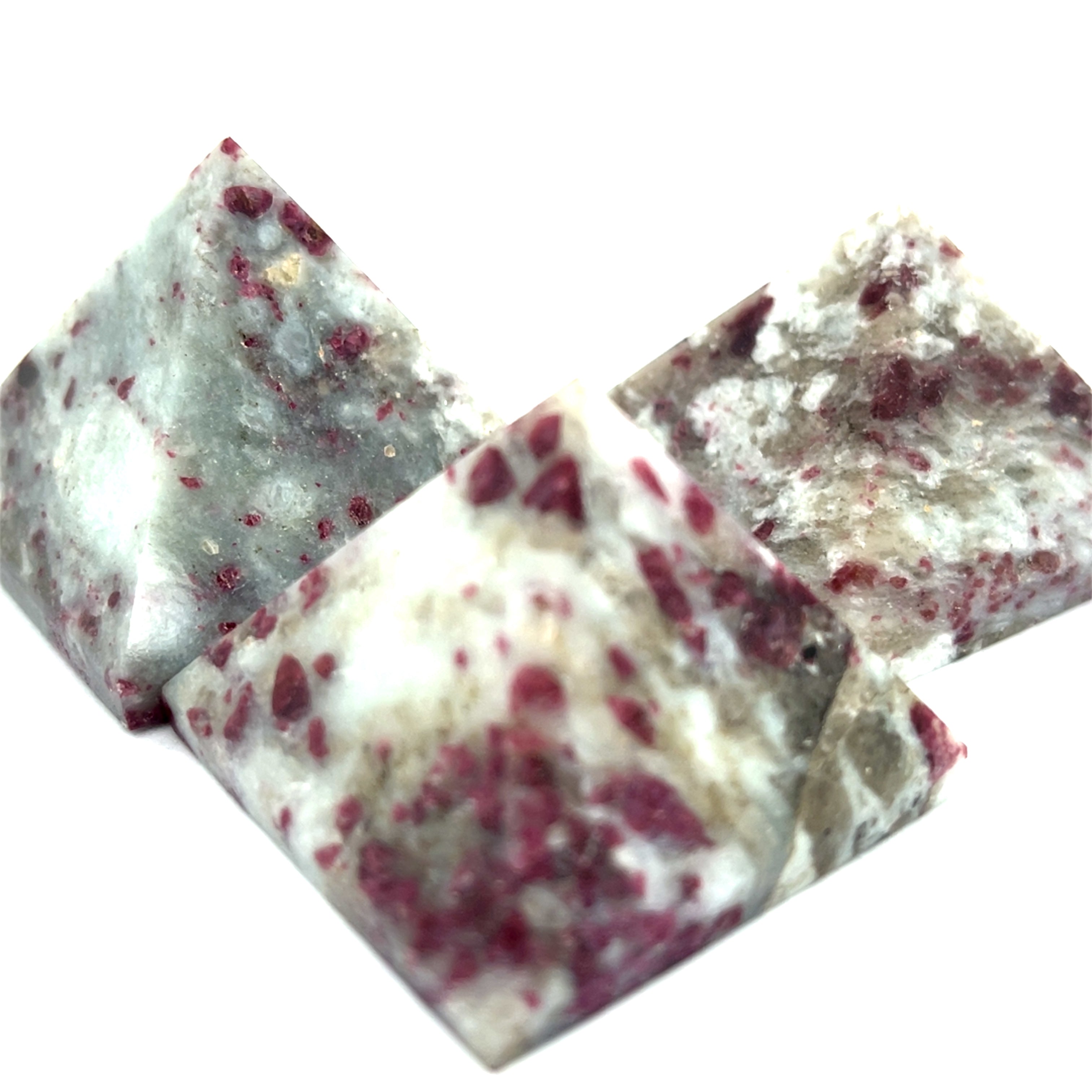 A group of  Pink Tourmaline Pyramid used for heart chakra meditation and energy healing on a white background overview. 