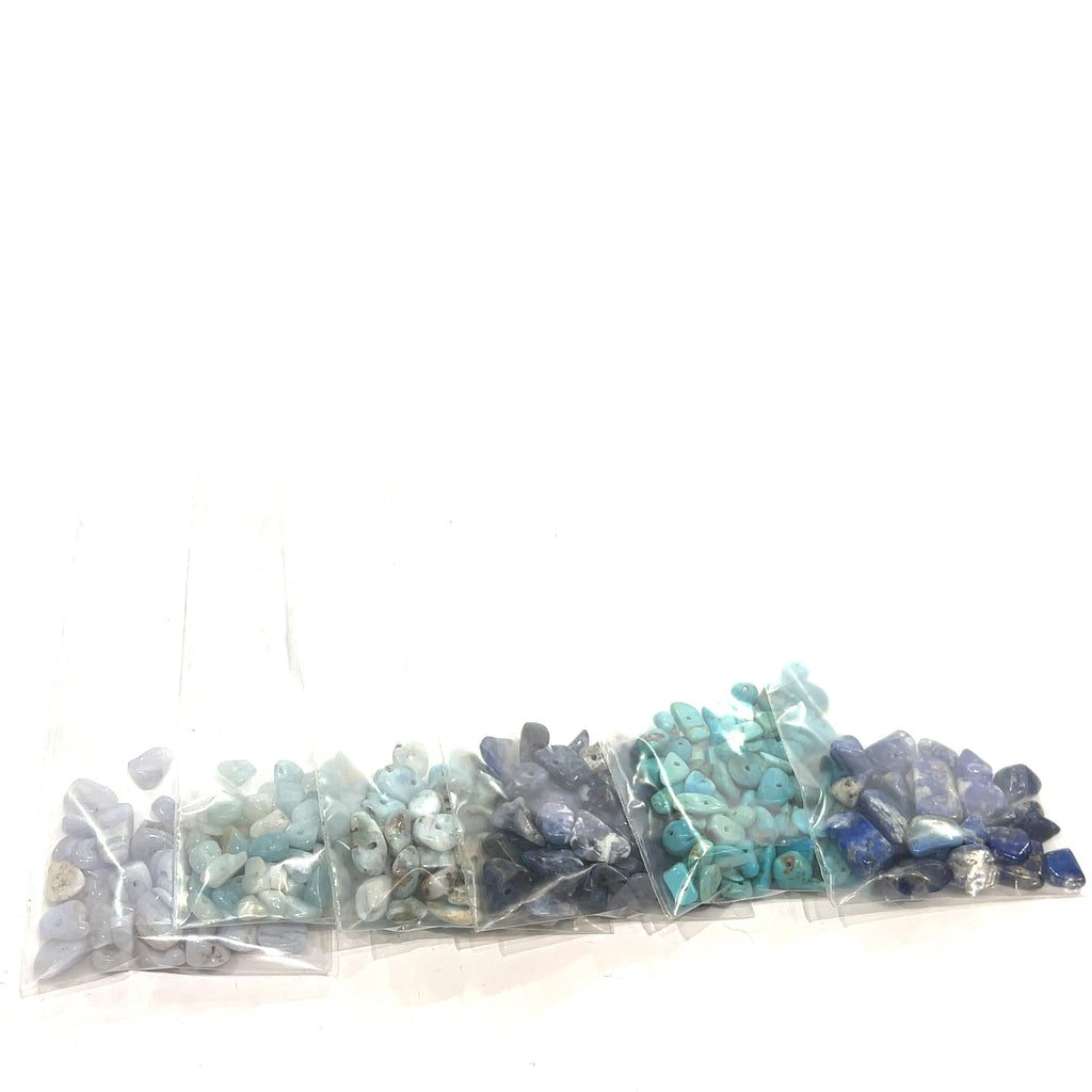A group of blue rays of gemstone chip bags, on a white background, front view.
