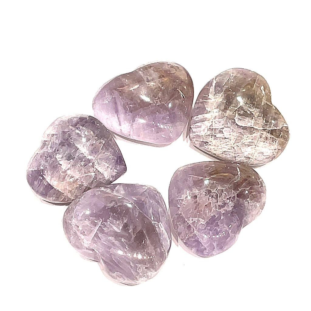 A group of five Super Seven gemstone heart carving, on a white background for a close-up, overview