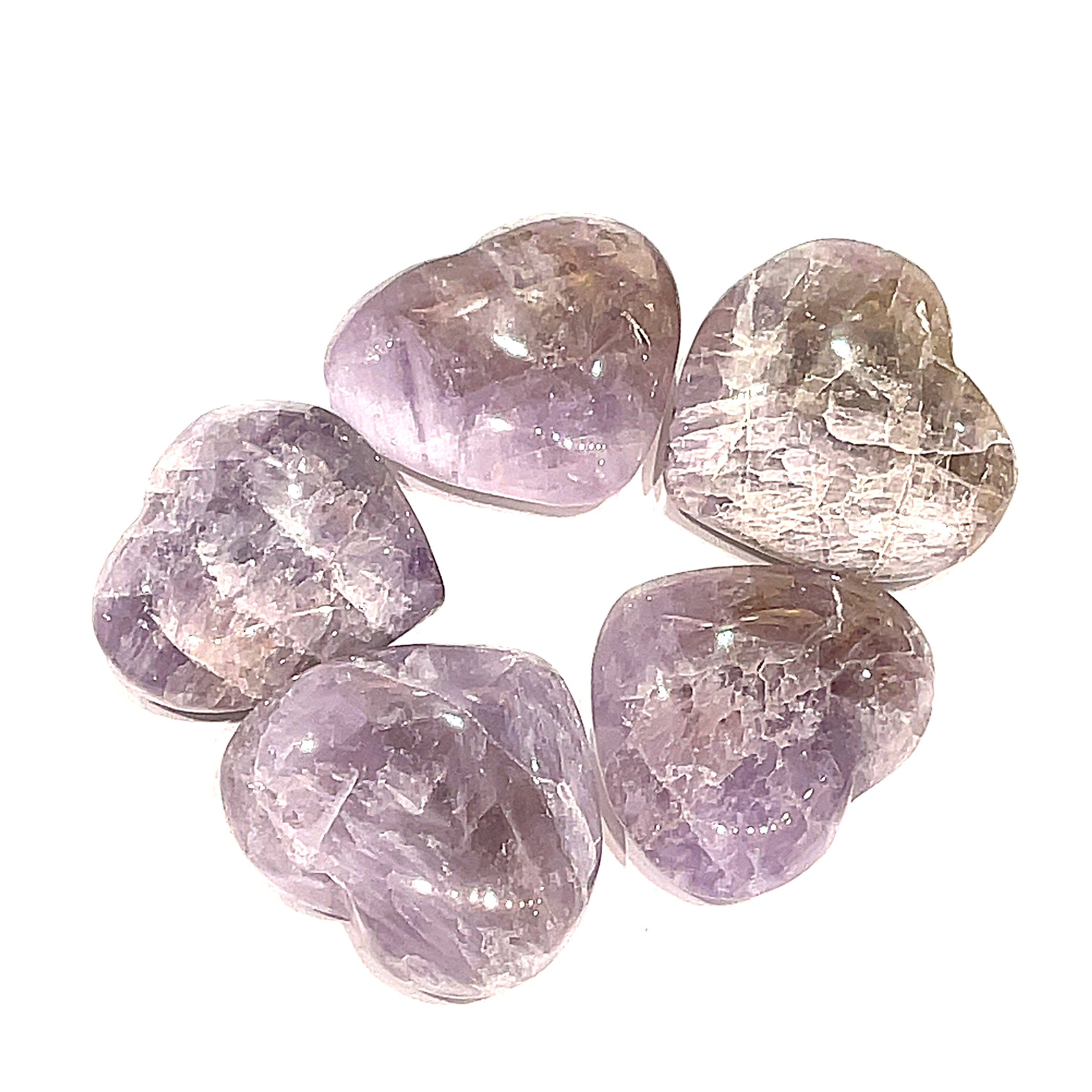 A group of five Super Seven gemstone heart carving, on a white background for a close-up, overview