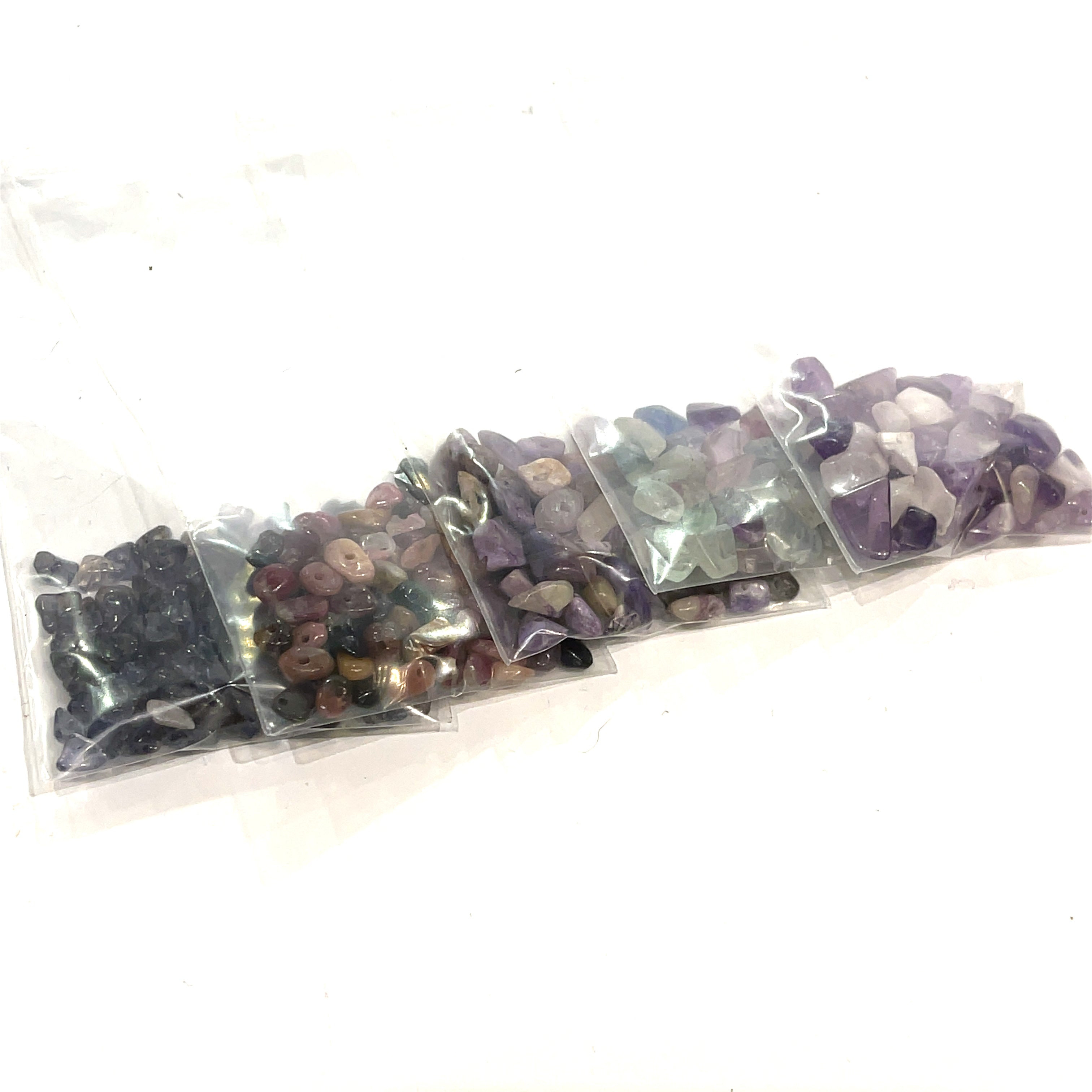 A group of purple, black rays of gemstone chip bags, on a white background, front view.