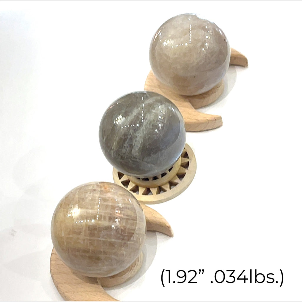 A grouping of  Grey Moonstone Sphere for meditation, balance, and chakra work (1.92''/.034 lbs.)on a white background a close up view. 