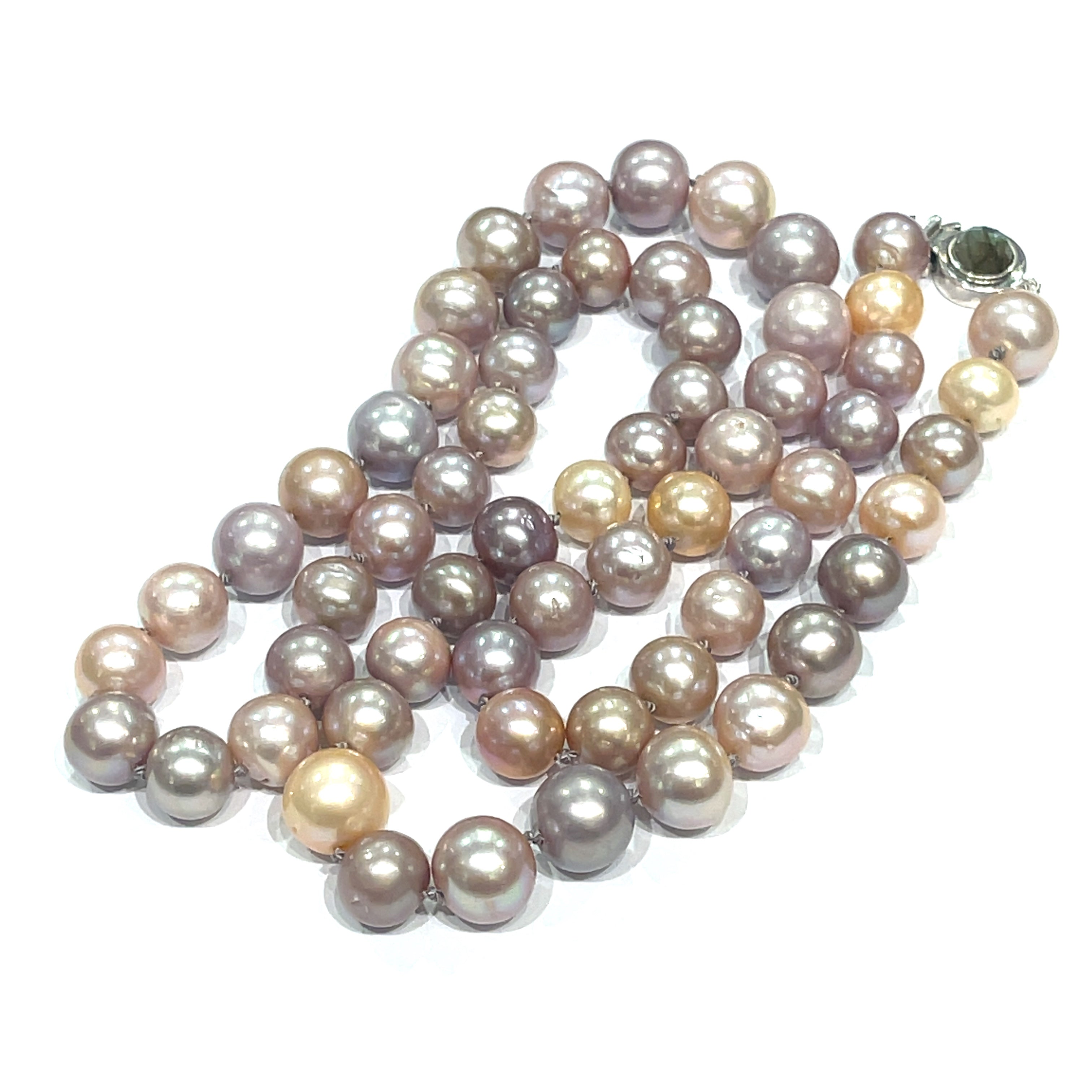 A knotted necklace featuring Edison pearls in varying shades of silver and gold, with a sterling silver box clasp and a bezel set labradorite gemstone. On a white background, center front overview.
