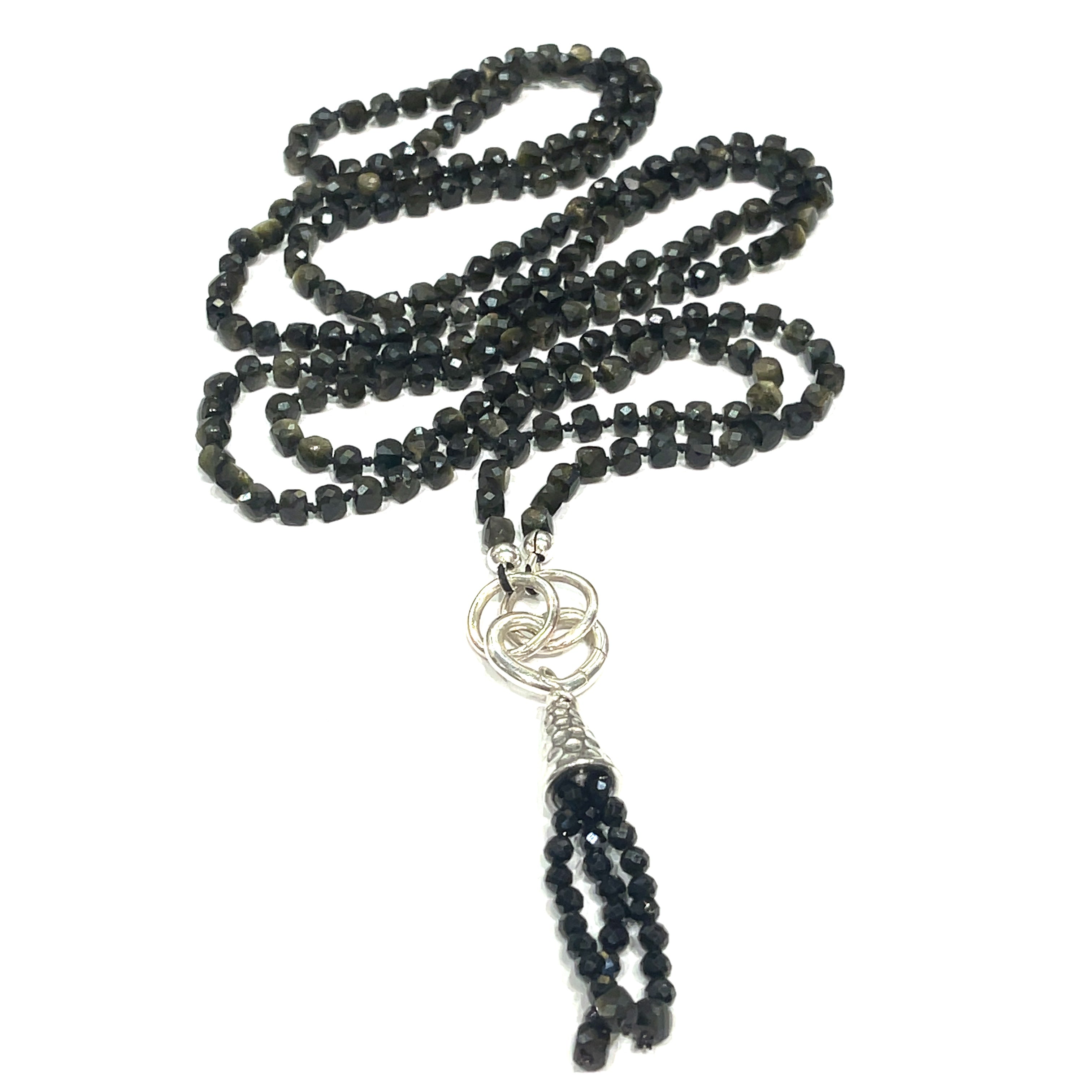 A knotted necklace made of Golden Sheen Obsidian gemstones with a tassel, featuring silver accents. On a white background, a spiral, long overview. 