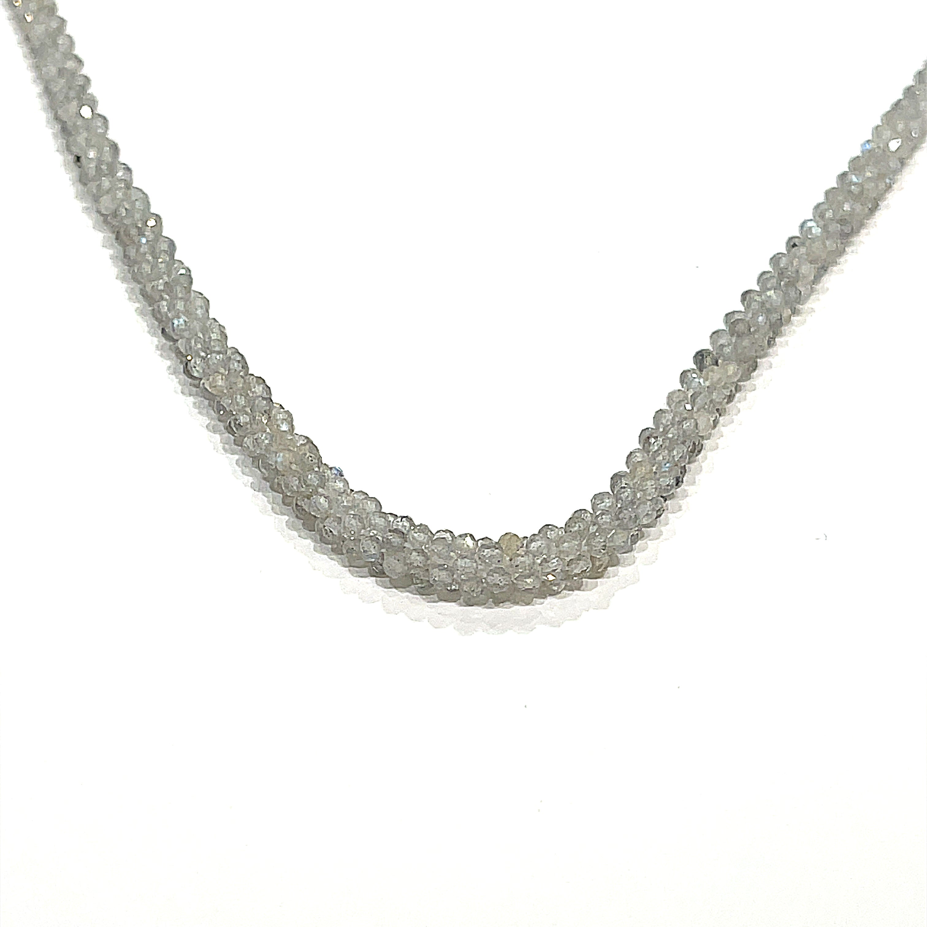A labradorite gemstone crocheted necklace with a sterling silver toggle. Displayed on a white background, long, center hanging overview. 