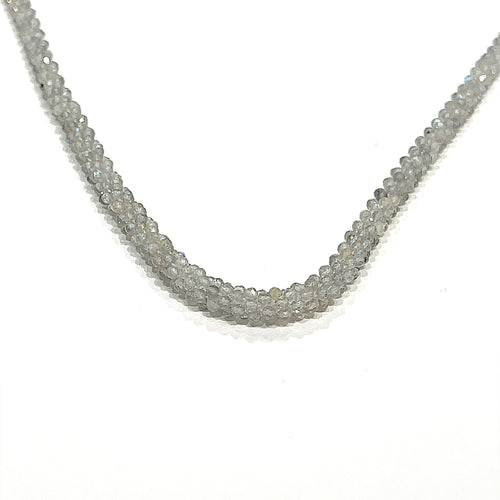 A labradorite gemstone crocheted necklace with a sterling silver toggle. Displayed on a white background, long, center hanging overview. 