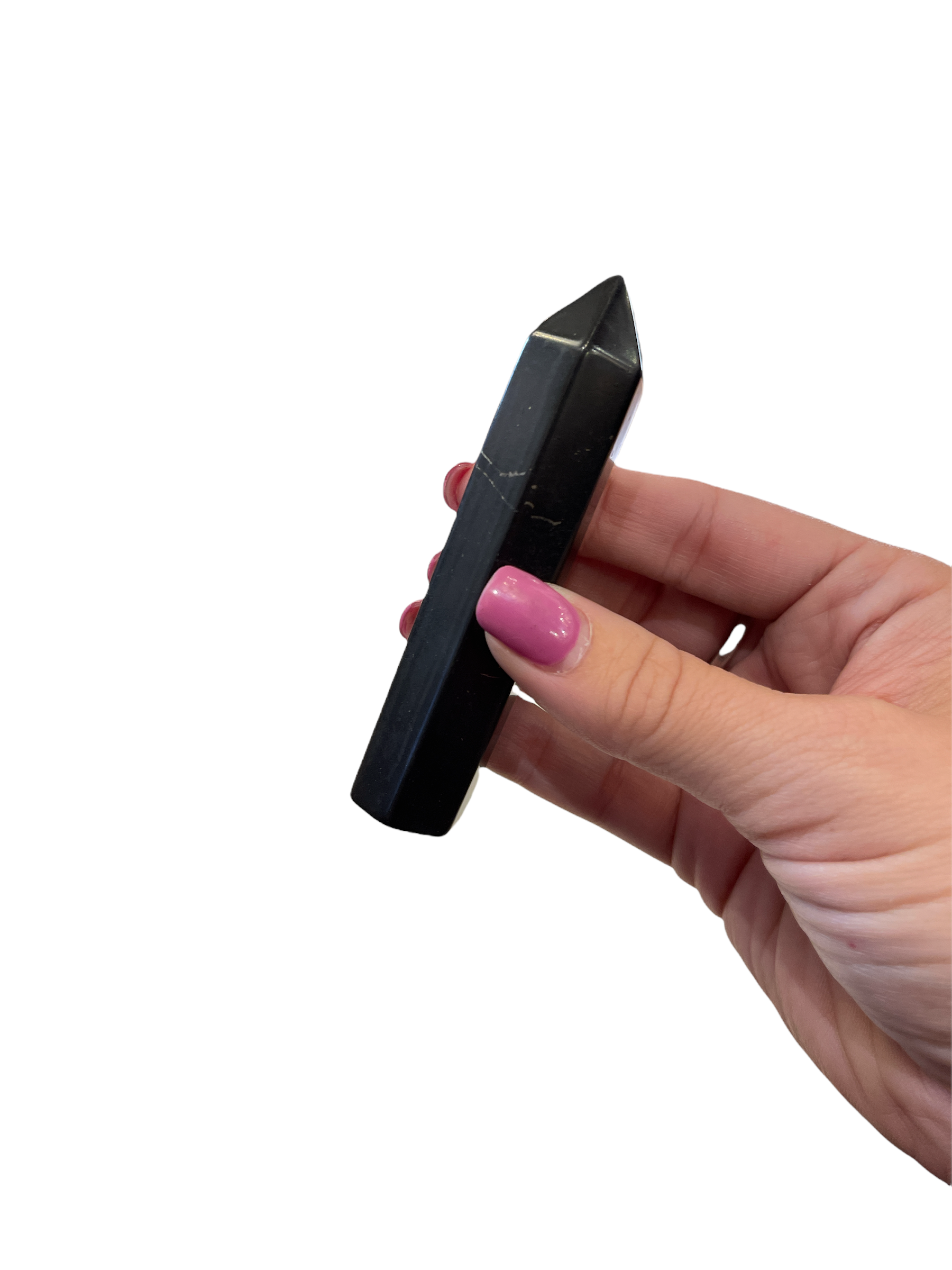 A large sungite gemstone tower in a models finger tips dispalyed on a white background, front view. 