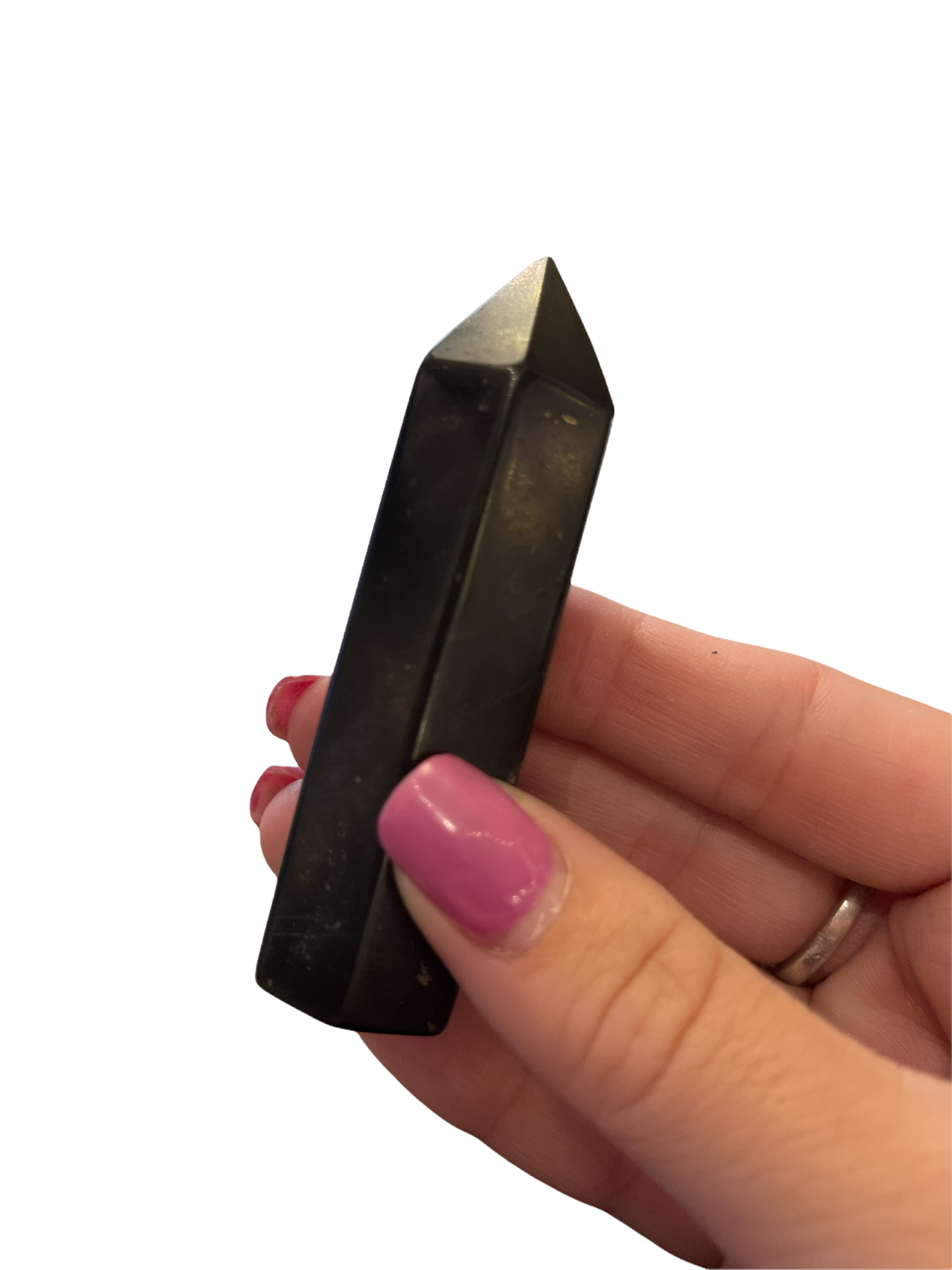 A medium sungite gemstone tower in a models finger tips dispalyed on a white background, front view. 