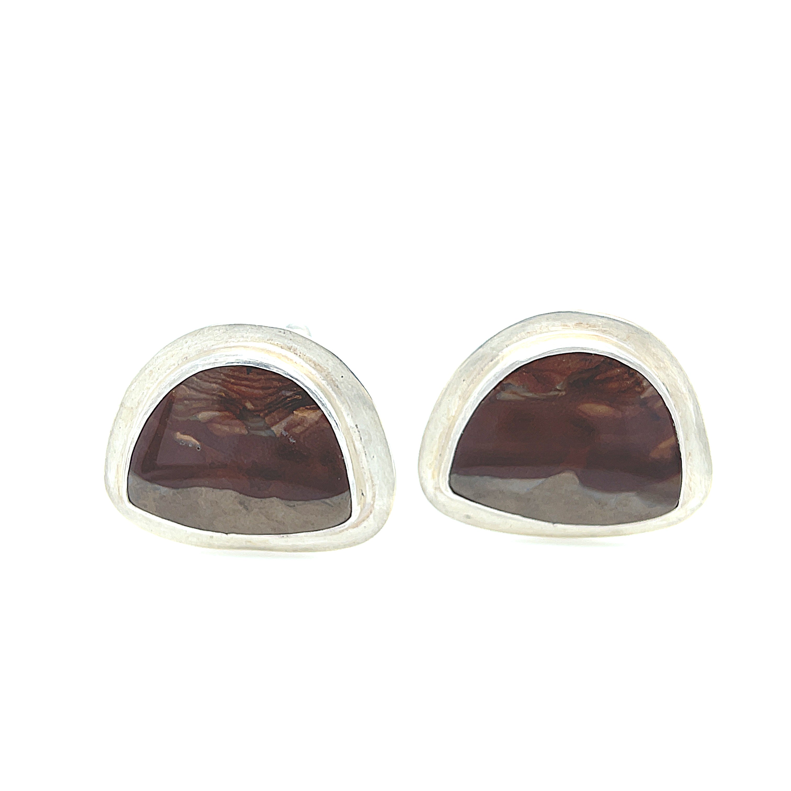A pair of sterling silver cufflinks featuring rounded-triangle-shaped mookite jasper gemstones, bezel-set in a round sterling silver setting. On a white background, front center close up view.