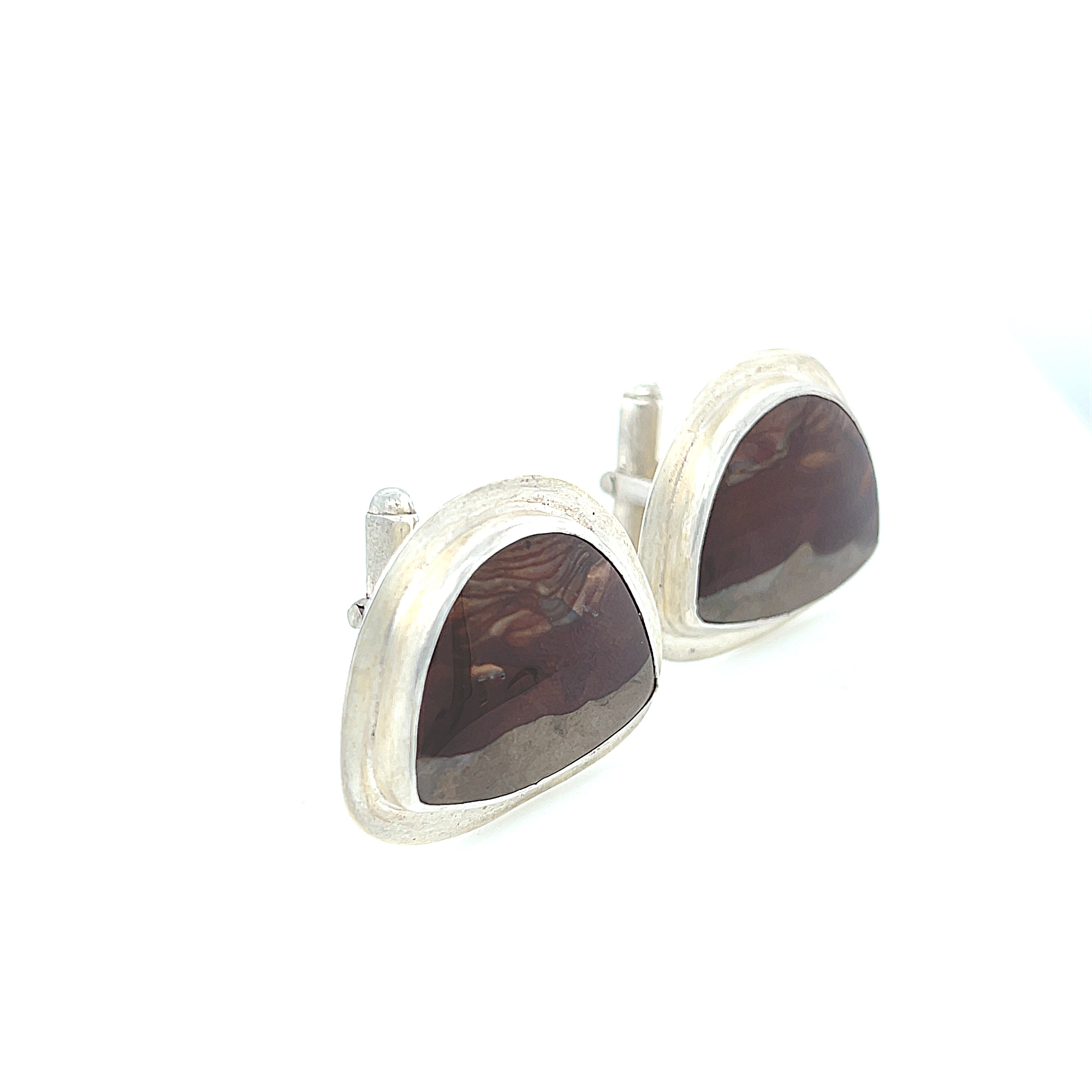A pair of sterling silver cufflinks featuring rounded-triangle-shaped mookite jasper gemstones, bezel-set in a round sterling silver setting. On a white background, right-angle front view.