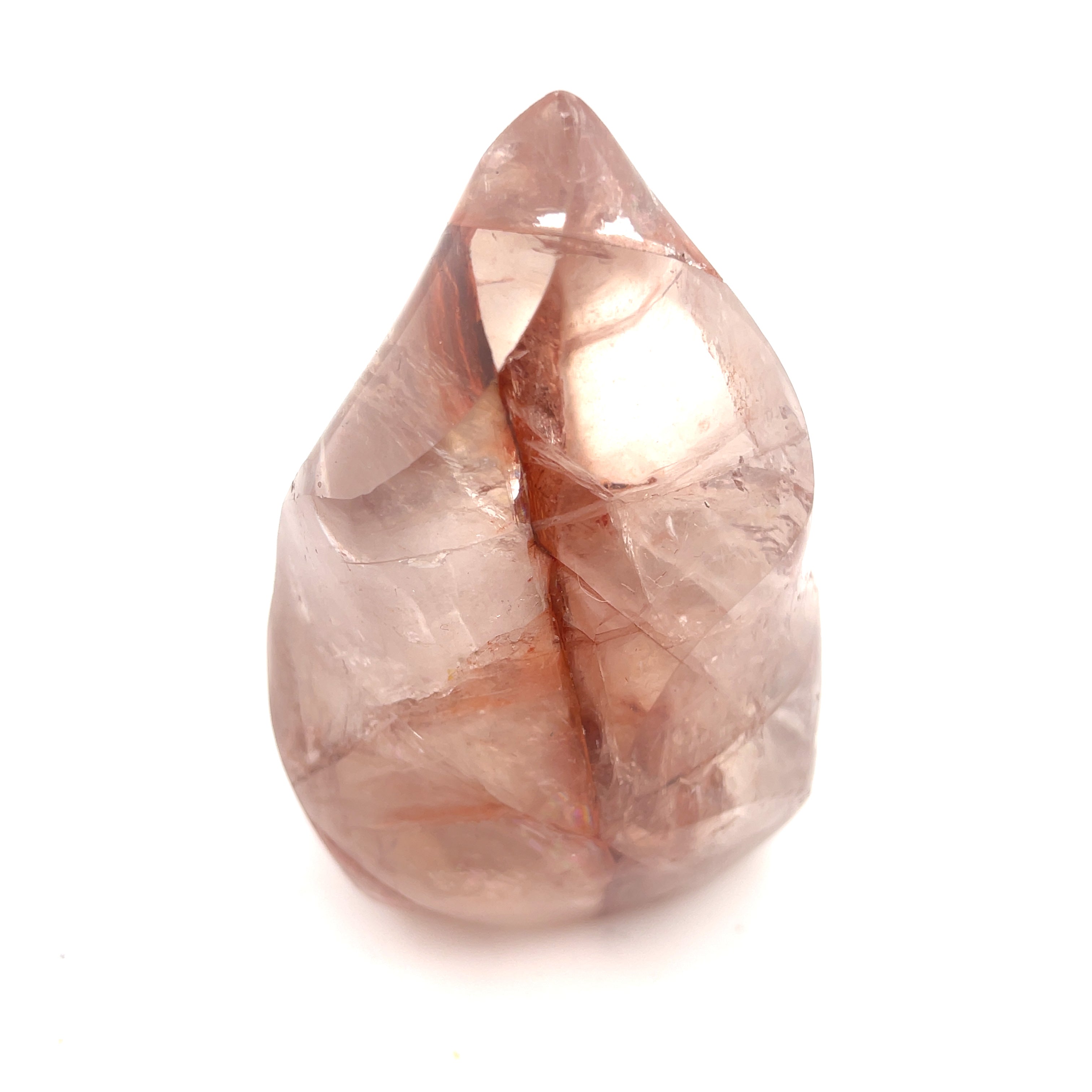 A polished Fire Quartz gemstones with a flame-like carving and a pink to red gradient on a white background front close up overview.