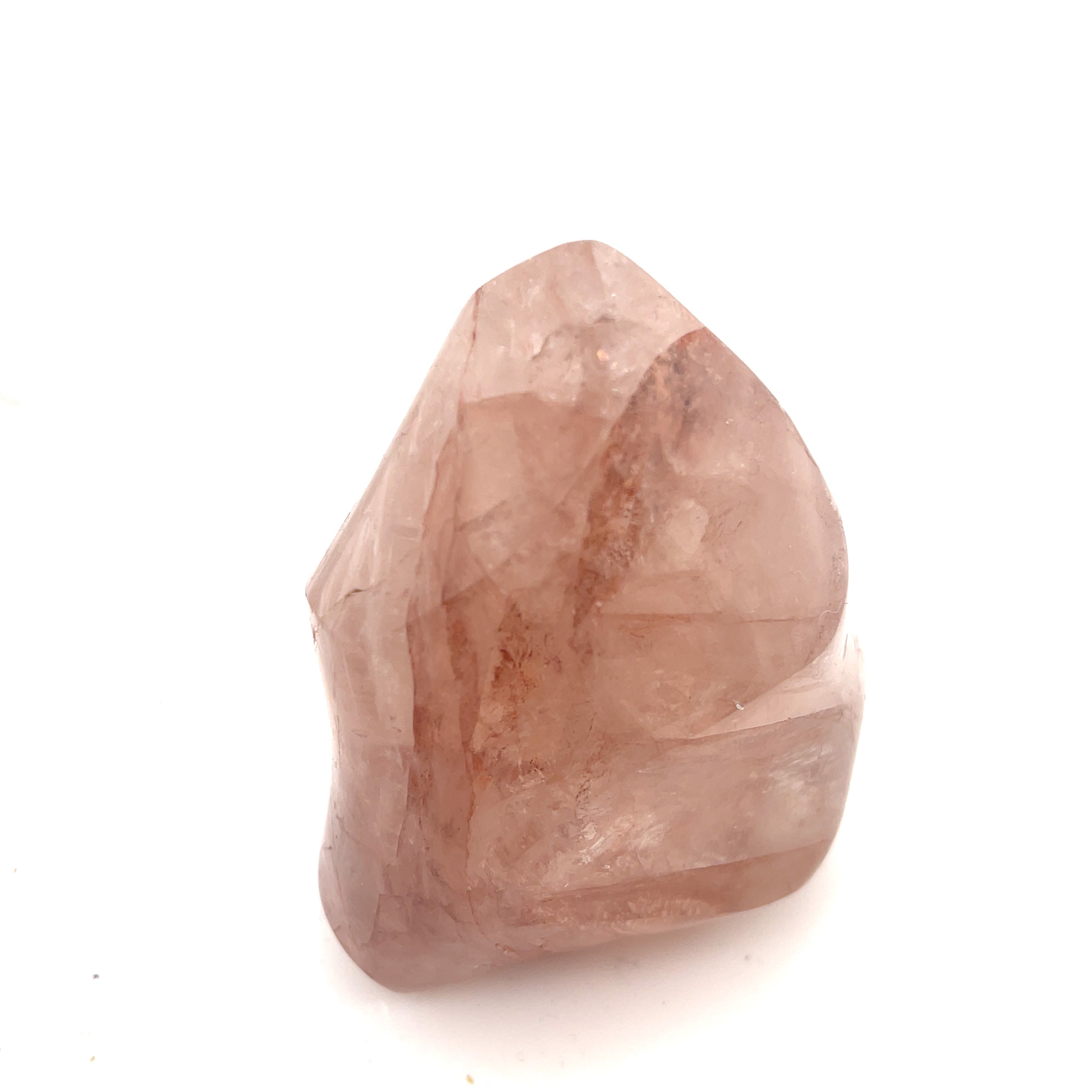 A polished Fire Quartz gemstones with a flame-like carving and a pink to red gradient on a white background front close up view.