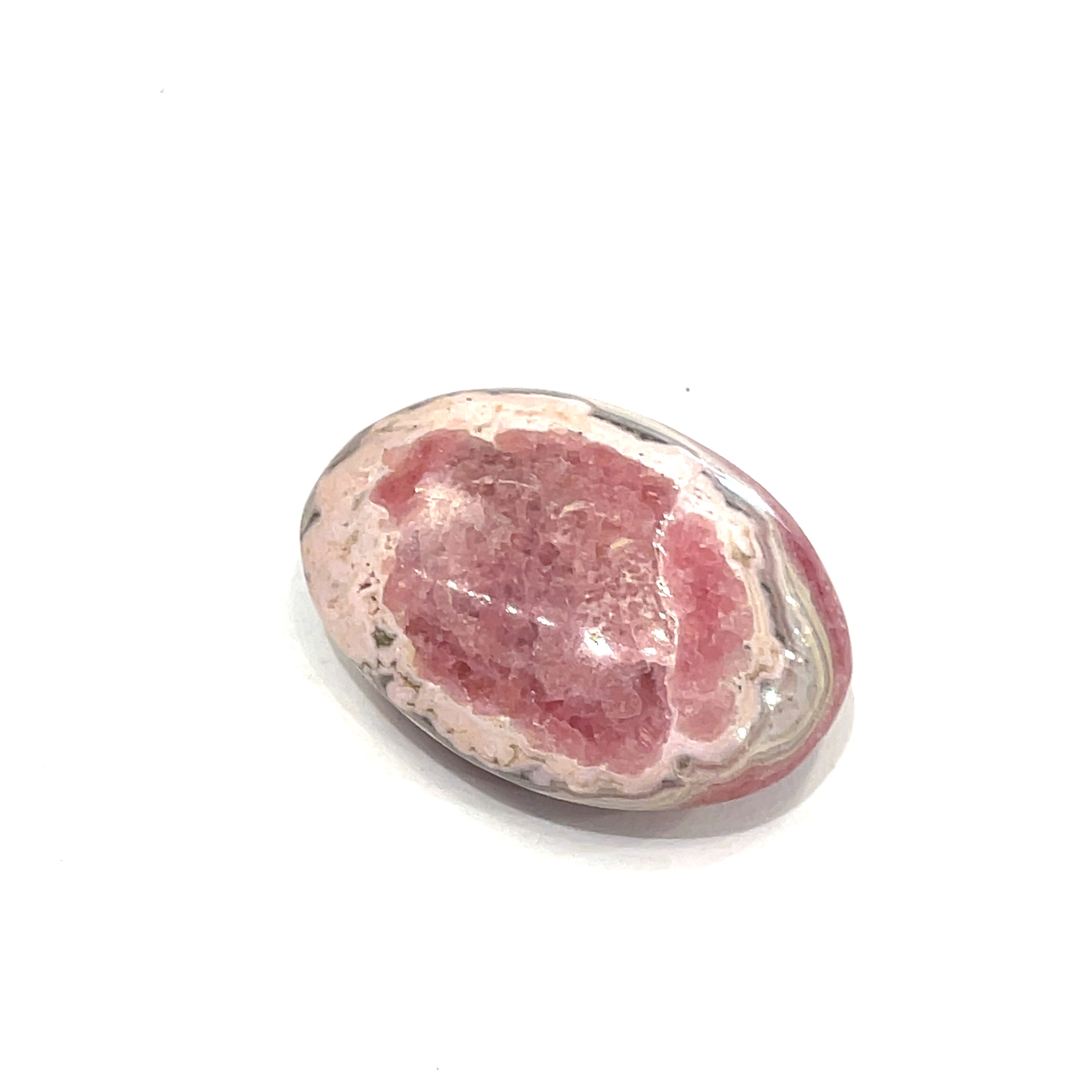 A polished Rhodochrosite gemstone palm stones with varying shades of pink to pale brown colors and white streaks on a white background front view.