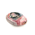 A polished Rhodochrosite gemstone palm stones with varying shades of pink to pale brown colors and white streaks on a white background side view.