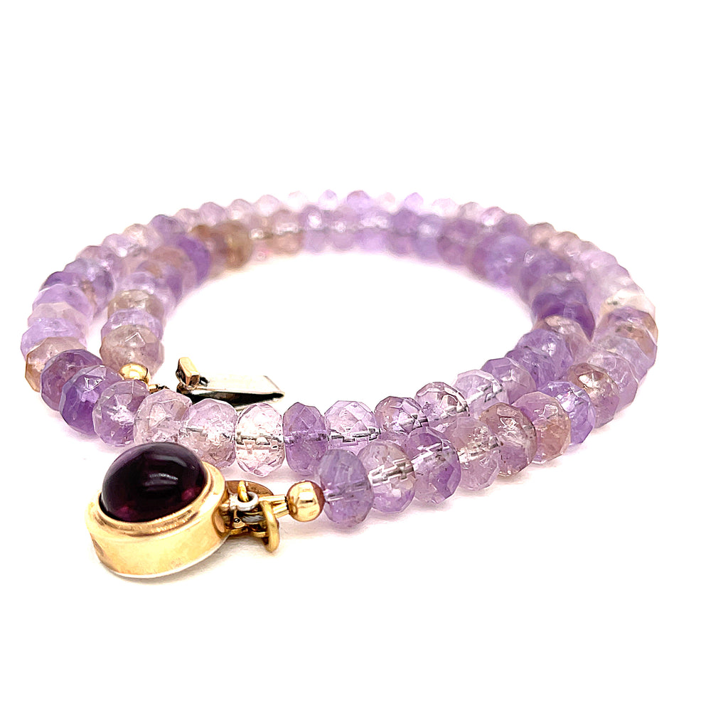 A purple ametrine beaded gemstone necklace with a gold-filled fluorite box clasp in a spiral, box clasp overview on a white background. 