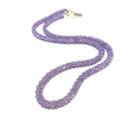 A purple zircon gemstone crocheted necklace with a sterling silver toggle, on a white background. A long front overview. 