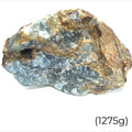 A raw Blue Onyx gemstone with a rough, uncut surface showing shades of blue and brown (11275g) on a white background, front view. 