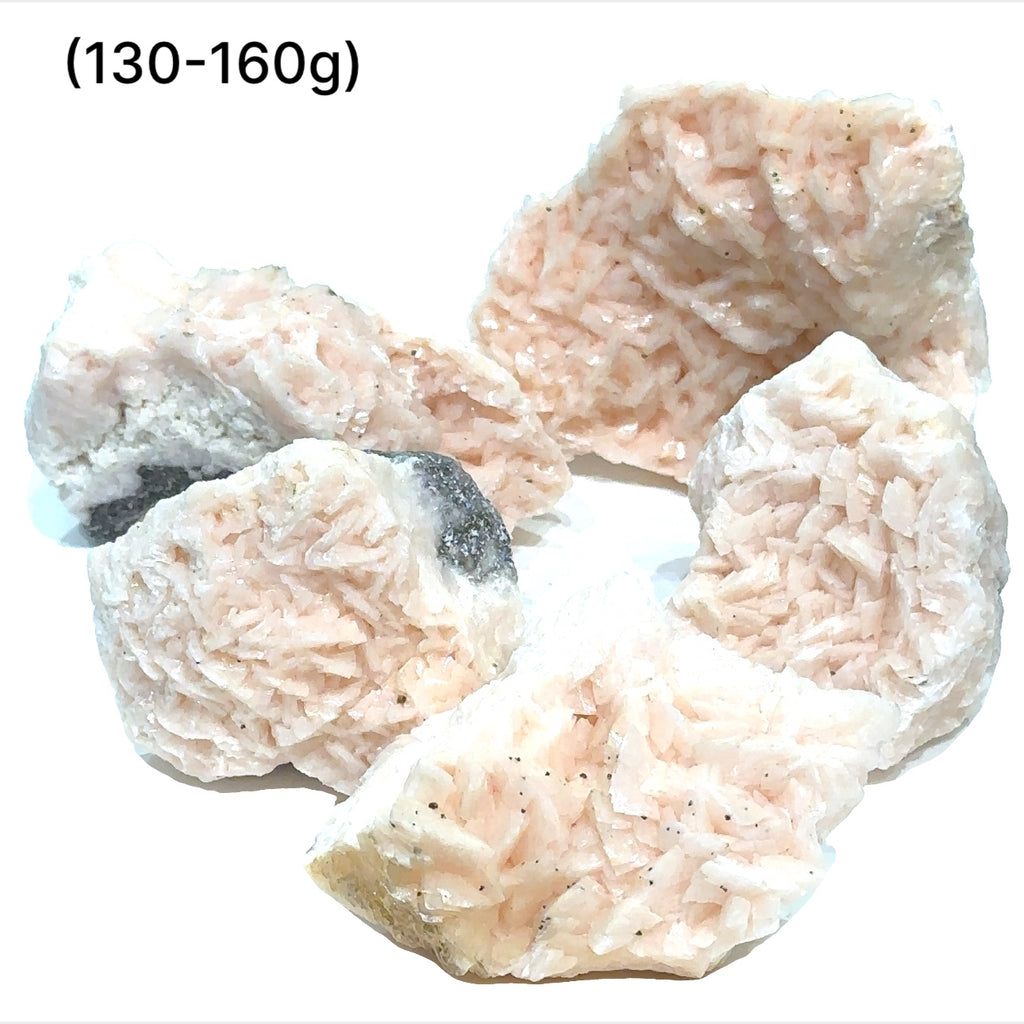 A raw specimen of Pink Dolomite with Chalcopyrite, showing a rough, crystalline texture with specks of color on a white background, in a close-up view (130-160g)