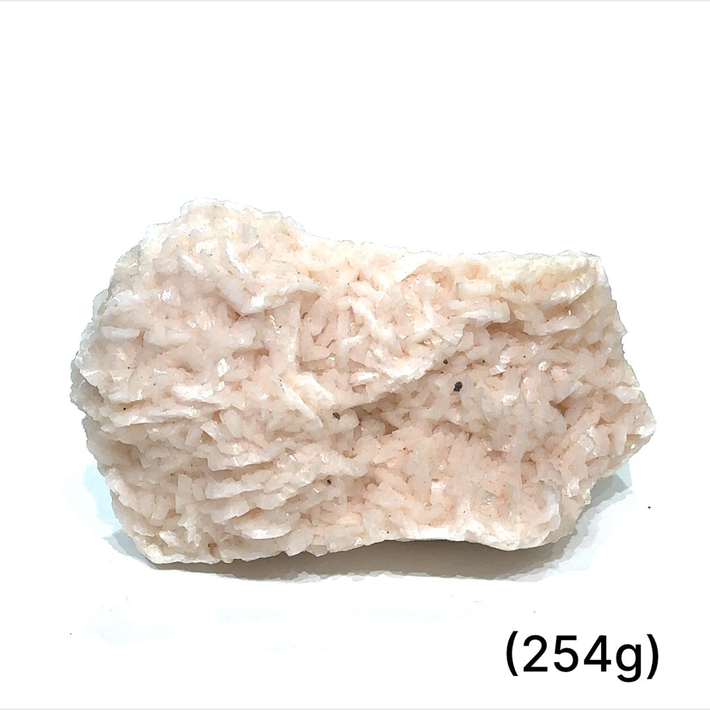 A raw specimen of Pink Dolomite with Chalcopyrite, showing a rough, crystalline texture with specks of color on a white background, in a close-up view (254g)