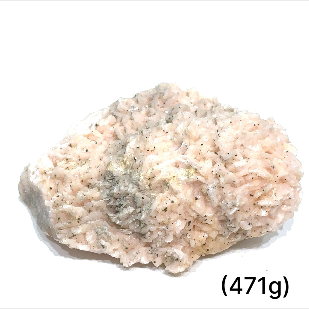 A raw specimen of Pink Dolomite with Chalcopyrite, showing a rough, crystalline texture with specks of color on a white background, in a close-up view (471g)